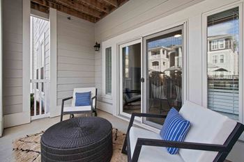 a screened in porch with a chair and a couch